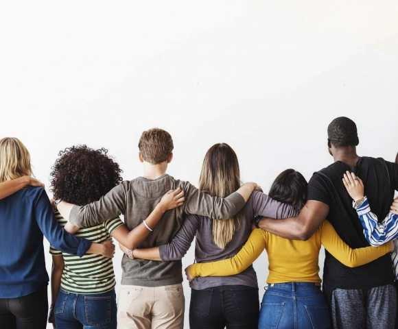 Rearview of diverse people hugging each other