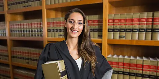 law student standing front of the bookshelf