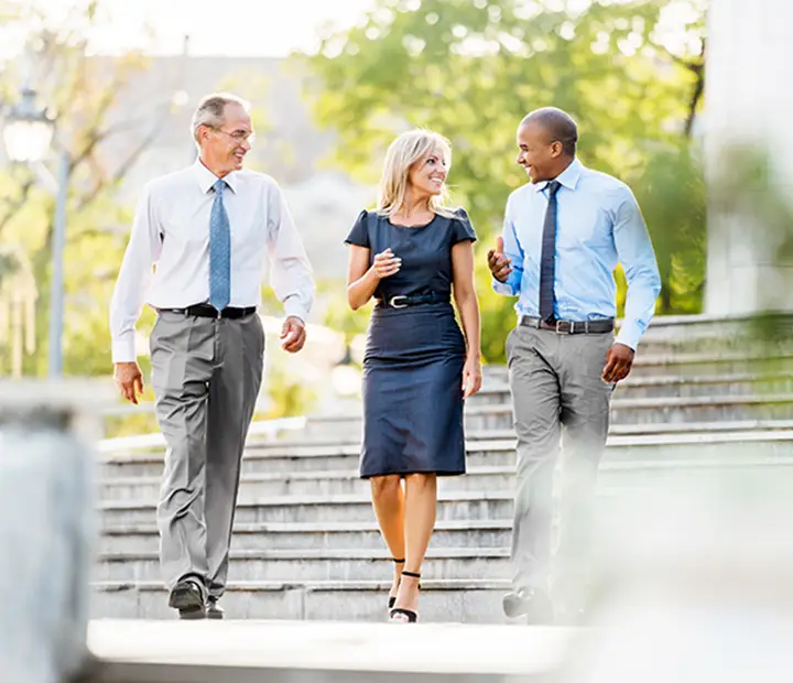 Colleagues walking down the sidewalk together.