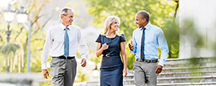 Colleagues walking down the sidewalk together.