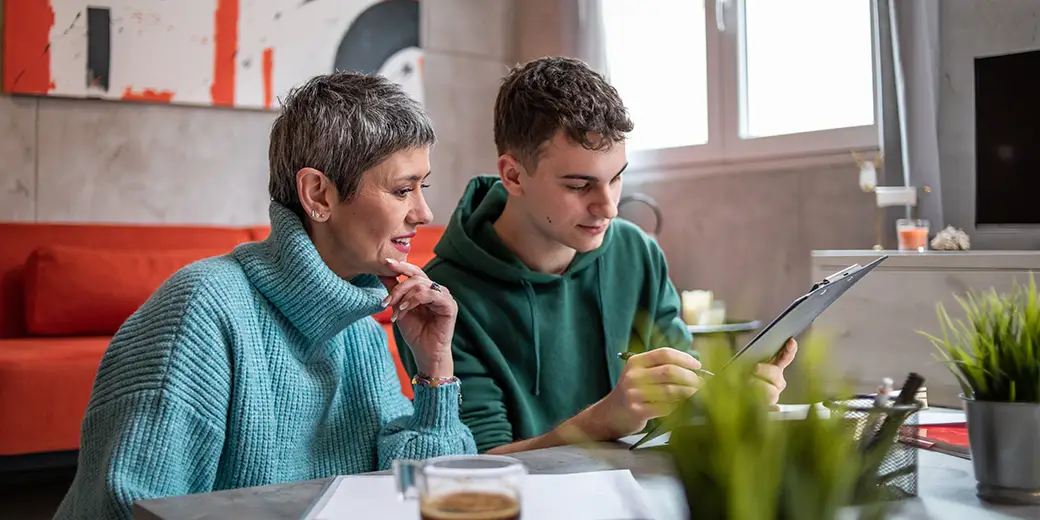 mother and son looking over student loan options