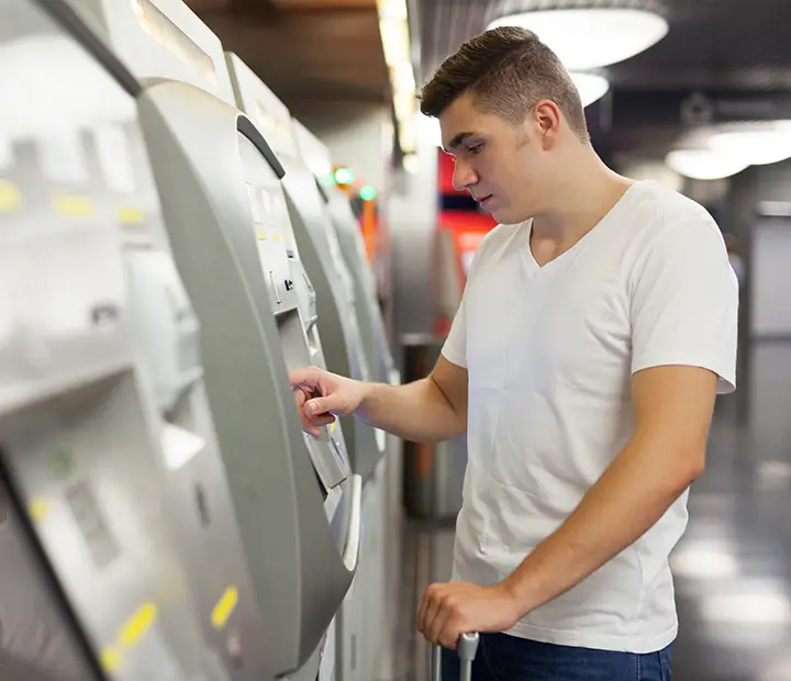 military man in civilian clothes using the ATM