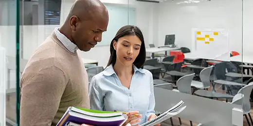 two students conversing in MBA class