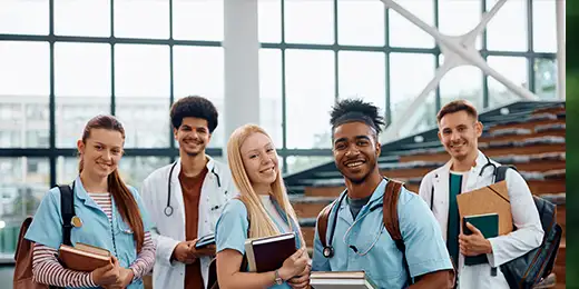 multiple medical students posing by the stair