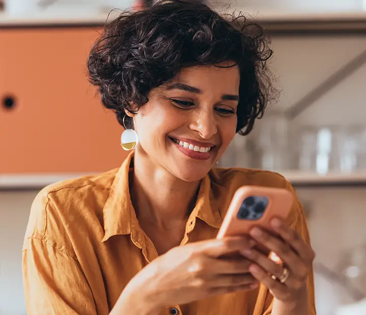 smiling woman holding a cell phone
