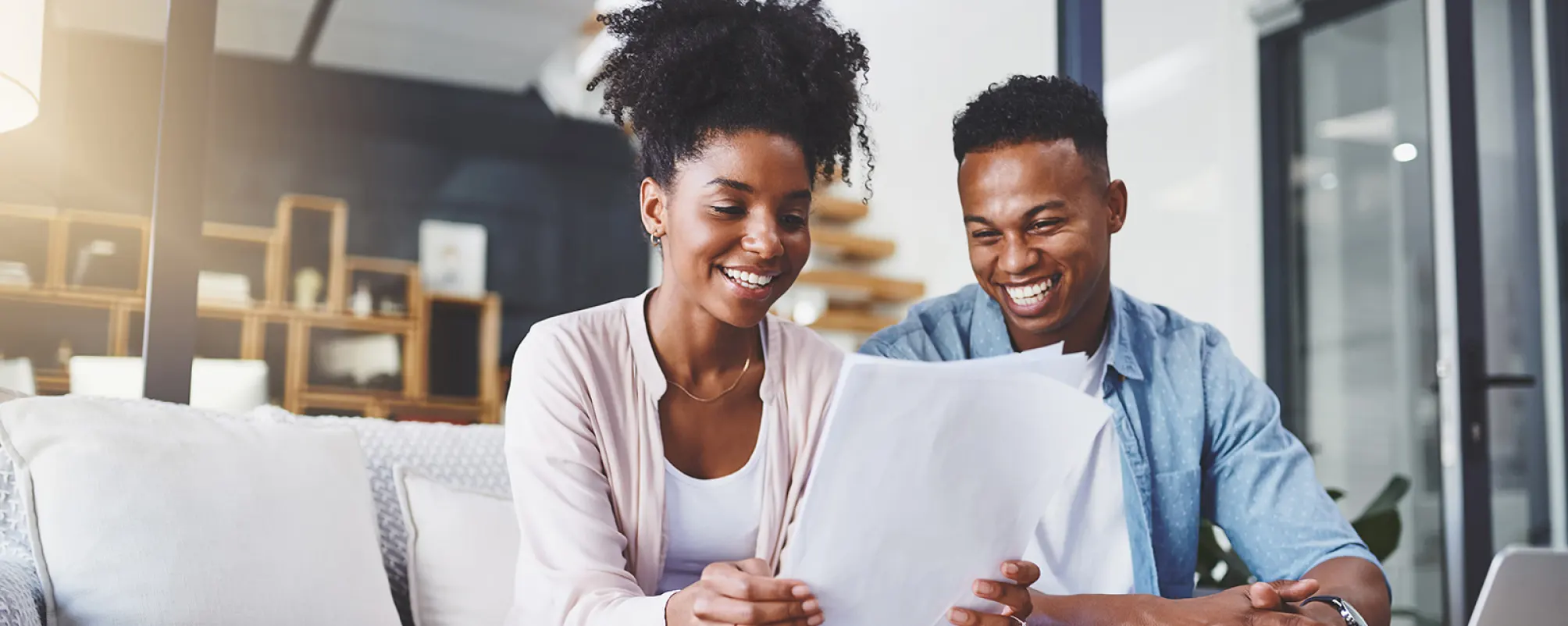 young couple checking their finances in the living room