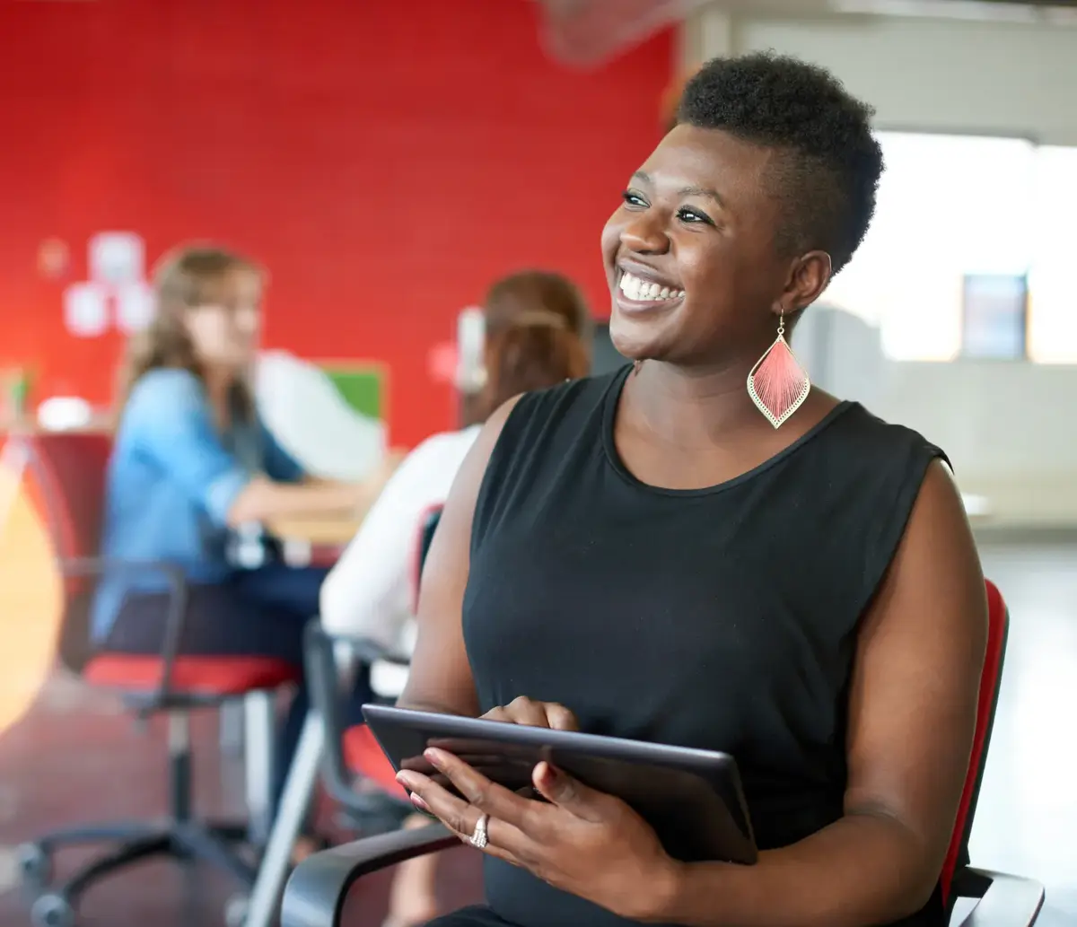 Lady smiling while working on her iPad